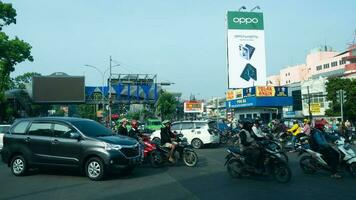 Bogor, West Java, Indonesia, May 2 2023 - Very heavy traffic of cars and motorcycle at one of the intersections of Bogor city during a sunny day. photo