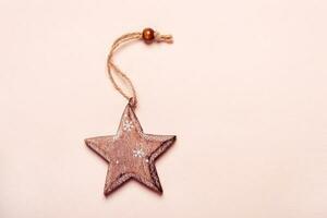 Vintage silver Christmas toy wooden star on pink background photo