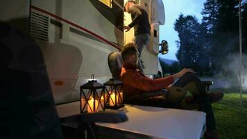 Two Mens and the RV Camper Van Motorhome Camping Site. Summer Time Recreation with Motorcoach. video