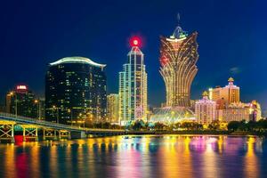 skyline of macau by the sea at night in china photo