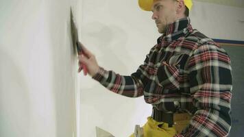 Caucasian Construction Worker Patching Drywall Walls video