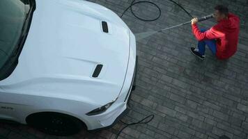 Caucasian Men in His 30s Cleaning His Modern Convertible Using Pressure Washer and Specialized Detergent. video