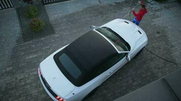 Men in His 30s Cleaning His Modern Convertible Using Pressure Washer. Top View. video