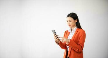 Portrait photo of young beautiful Asian woman feeling happy and holding smart phone, tablet and laptop with black empty screen on white background can use for advertising or product concept.