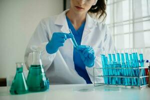 Modern medical research laboratory. female scientist working with micro pipettes analyzing biochemical samples, advanced science chemical laboratory for medicine. photo