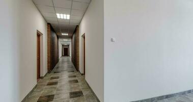 circular loop panoramic movement in circle of white empty long corridor room in office building video