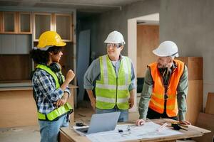 Engineers are discussing data working and laptop or tablet with architectural project at new construction site on big project. photo