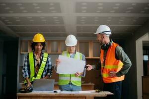 Engineers are discussing data working and laptop or tablet with architectural project at new construction site on big project. photo