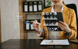 Businessman hand Project manager working and update tasks and Gantt chart scheduling virtual diagram.with smart phone, tablet and laptop photo