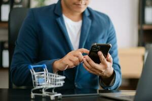 Cart Online Shopping concept. businesswoman hand using smart phone, tablet payments and holding credit card online shopping, omni channel, computer photo