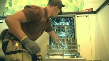 Technician Installing Brand New Dishwasher Inside a Kitchen video