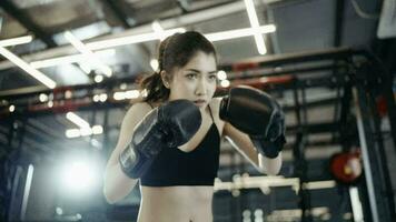 woman wearing workout clothes Boxing builds muscle and strength in the gym. video