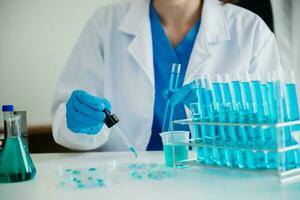 Modern medical research laboratory. female scientist working with micro pipettes analyzing biochemical samples, advanced science chemical laboratory for medicine. photo