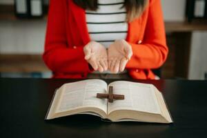 Woman praying on holy bible in the morning.Woman hand with Bible praying. Christian life crisis prayer to god. photo