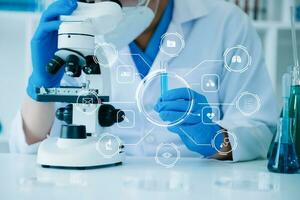 DNA molecule testing concepts. The doctor in a mask examines DNA molecules on the chemical laboratory with VR icon photo