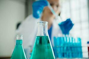 Modern medical research laboratory. female scientist working with micro pipettes analyzing biochemical samples, advanced science chemical laboratory for medicine. photo