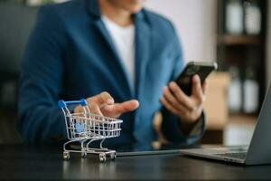 Cart Online Shopping concept. businesswoman hand using smart phone, tablet payments and holding credit card online shopping, omni channel, computer photo