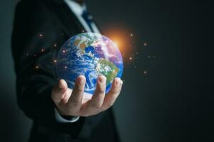 Businessman holding a model globe. concept of network communication. information network concept. photo