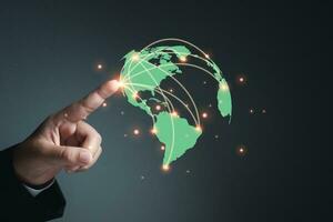 Businessman hand pointing at world map. concept of network communication photo