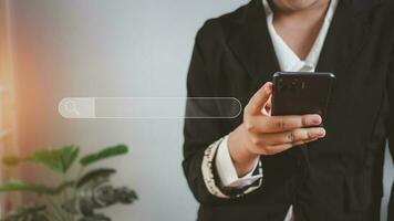 The concept of searching for information from the telephone network. Business woman standing and holding the phone with a search icon. photo