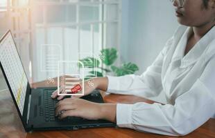 Business woman using a computer to complete Individual income tax return form online for tax payment. financial research, report. Calculation tax return. photo