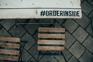 The empty wooden white table in the beer pub garden after the season with the hashtag and lettering on it photo