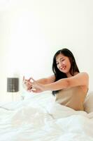 Wake up happy in the morning in bed Enough rest, full sleep, and a smile full of happiness. happy bedroom photo