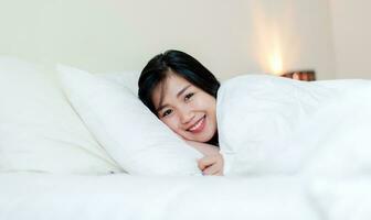 Wake up happy in the morning in bed Enough rest, full sleep, and a smile full of happiness. happy bedroom photo