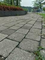 Background texture of a close-up cobblestone or paving slabs walkway in Bandung. Can be used for texture design and background with copy space. photo