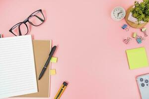 Pink office desk table Top view with copy space. Flat lay. photo