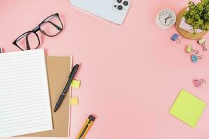 Pink office desk table Top view with copy space. Flat lay. photo