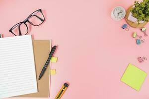 Pink office desk table Top view with copy space. Flat lay. photo