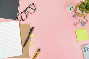 Pink office desk table Top view with copy space. Flat lay. photo