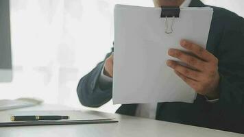 Close up Business woman using calculator and laptop for do math finance on wooden desk, tax, accounting, statistics and analytical research concept video