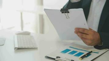 Close up Business woman using calculator and laptop for do math finance on wooden desk, tax, accounting, statistics and analytical research concept video