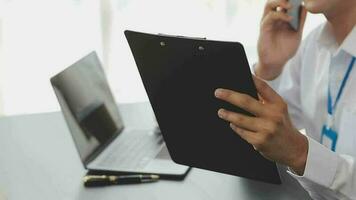 Close up Business woman using calculator and laptop for do math finance on wooden desk, tax, accounting, statistics and analytical research concept video