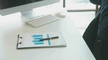 Close up Business woman using calculator and laptop for do math finance on wooden desk, tax, accounting, statistics and analytical research concept video