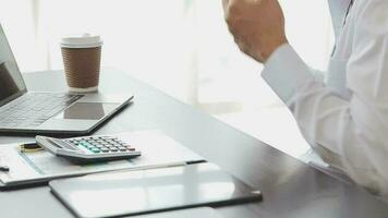 Close up Business woman using calculator and laptop for do math finance on wooden desk, tax, accounting, statistics and analytical research concept video