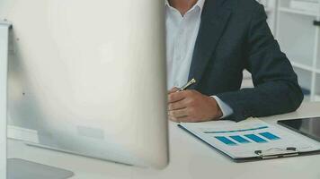 Close up Business woman using calculator and laptop for do math finance on wooden desk, tax, accounting, statistics and analytical research concept video