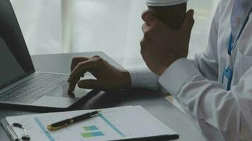 Close up Business woman using calculator and laptop for do math finance on wooden desk, tax, accounting, statistics and analytical research concept video