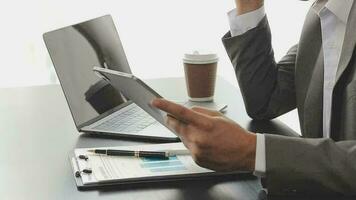 Close up Business woman using calculator and laptop for do math finance on wooden desk, tax, accounting, statistics and analytical research concept video