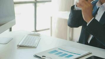 Close up Business woman using calculator and laptop for do math finance on wooden desk, tax, accounting, statistics and analytical research concept video