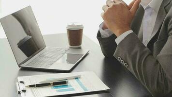 Close up Business woman using calculator and laptop for do math finance on wooden desk, tax, accounting, statistics and analytical research concept video