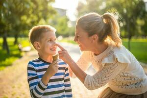 Mother and son playing in the park photo