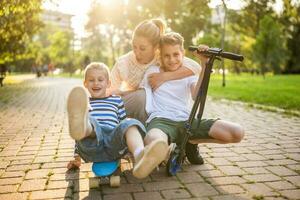 Mother playing her sons in the park photo