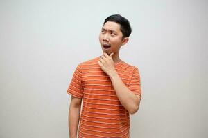 Asian man orange shirt amazed face looking up isolated photo