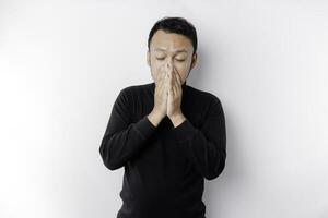 A portrait of an Asian man wearing a black shirt isolated by white background looks depressed photo