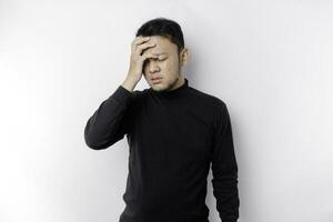 A portrait of an Asian man wearing a black shirt isolated by white background looks depressed photo