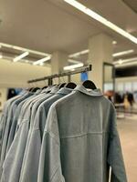 Shirts hanging on a hanger. Style and wardrobe for women. Shopping. photo