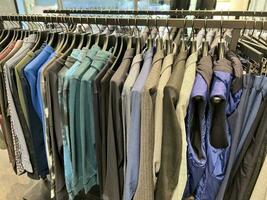 Clothes for men hang on a hanger. Style and wardrobe. Shopping. photo